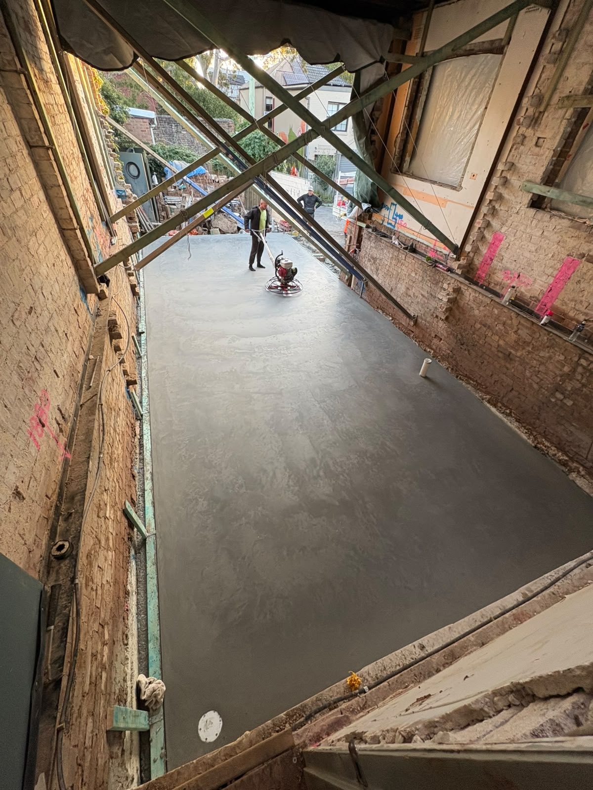Interior concrete floor finished with a power trowel