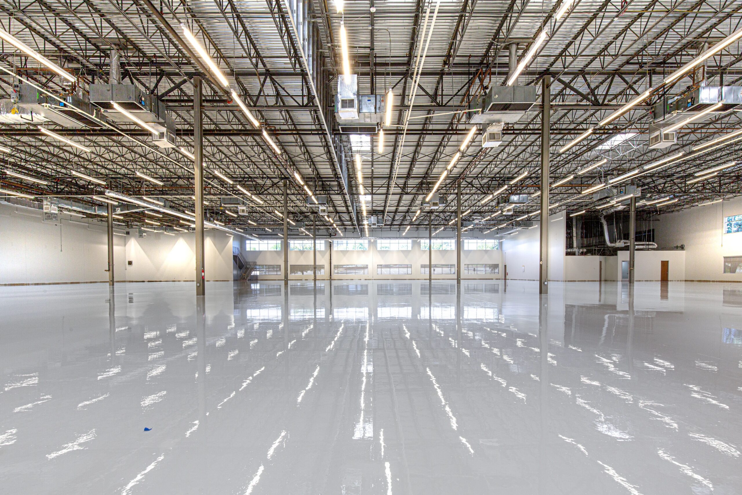 Large warehouse with a glossy light grey epoxy floor