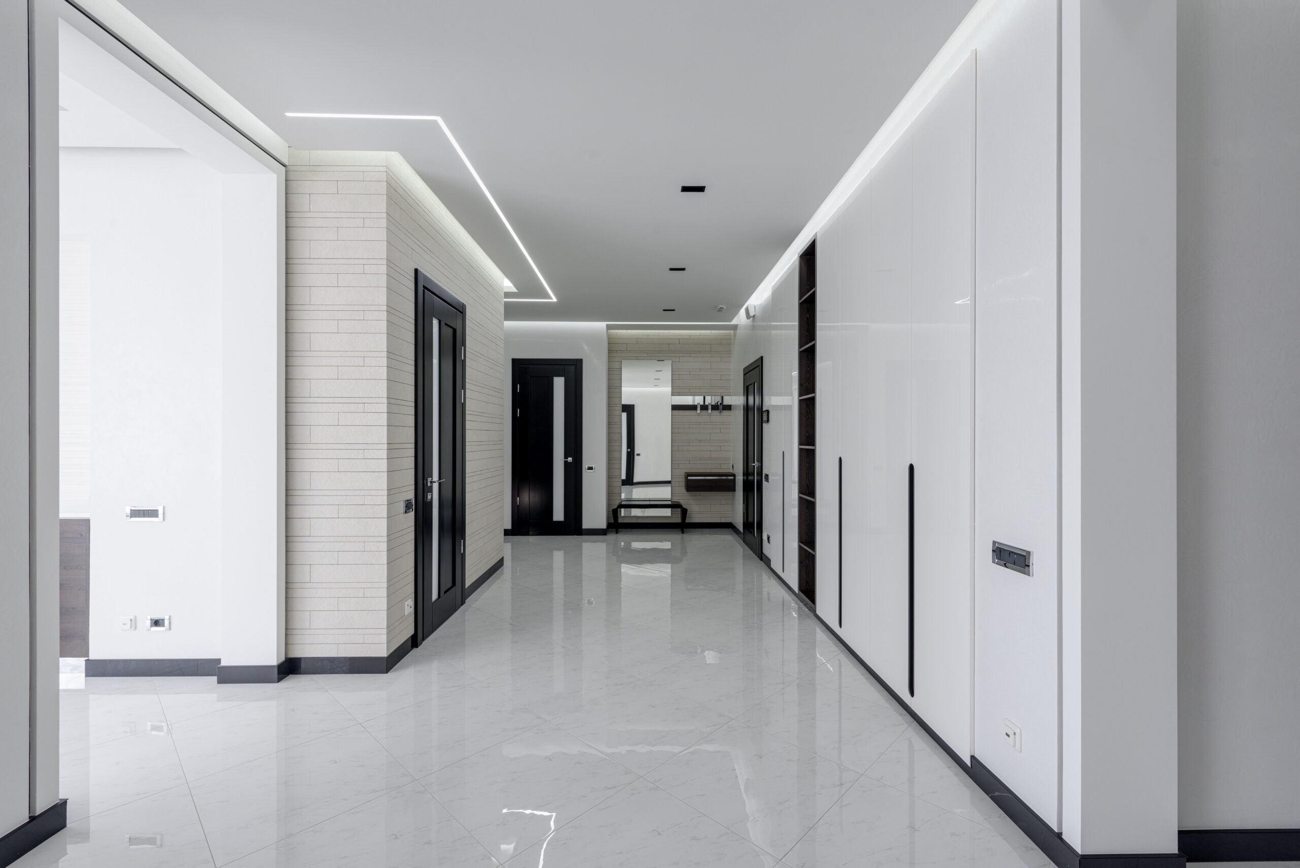 Glossy light epoxy floor running down a bright office corridor